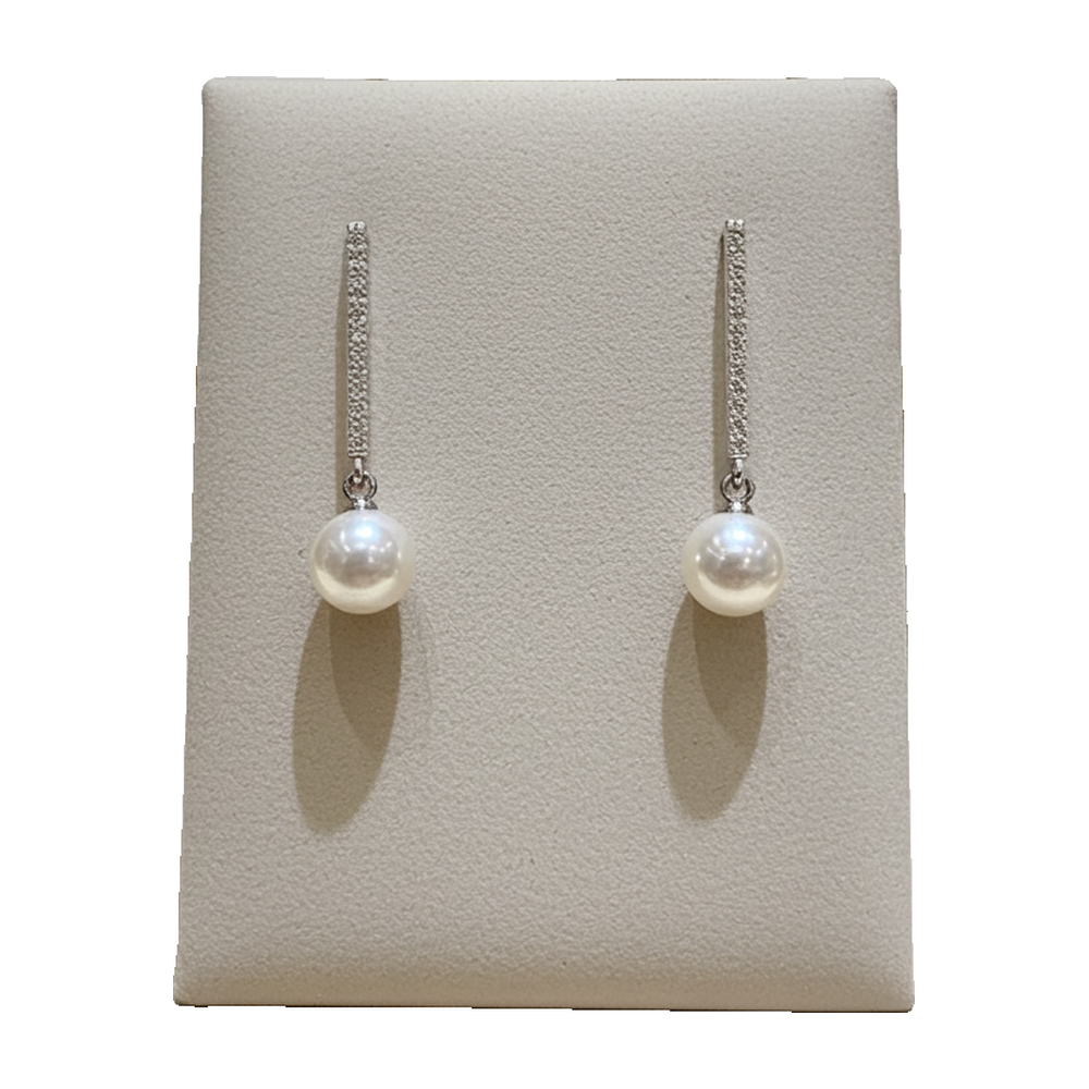 Faux pearl drop earrings with silver-tone pave bar, plain background, no props