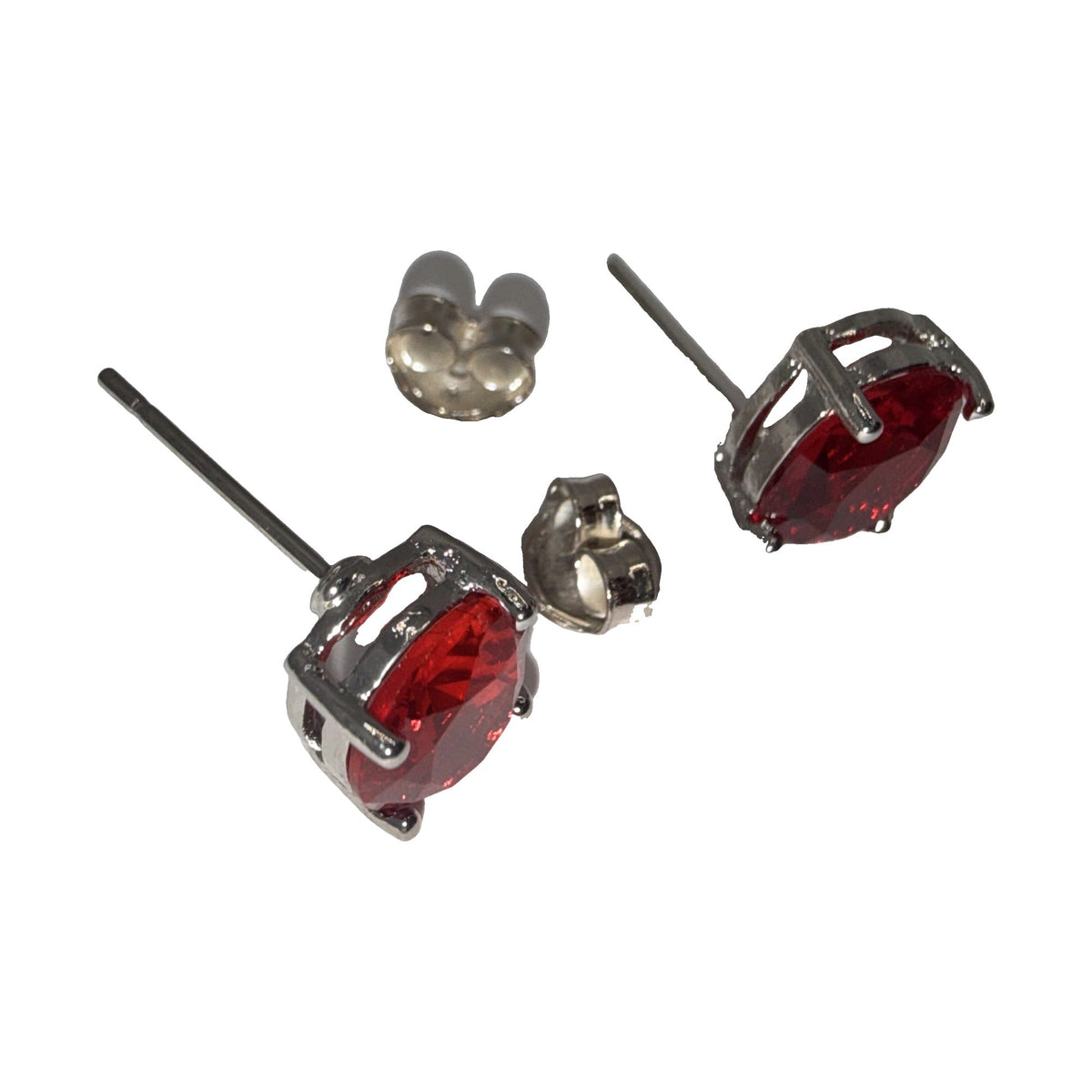 Silver-tone round red rhinestone stud earrings, angled view
