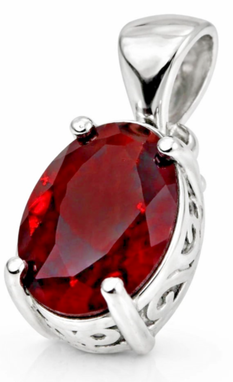 An oval-cut red gemstone pendant set in a polished silver-tone metal bezel with decorative scrollwork on the sides, shown on a white background.
