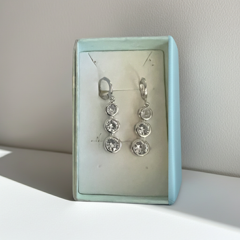 Three-stone bezel-set rhinestone drop earrings in silver-tone with leverback closure, further view