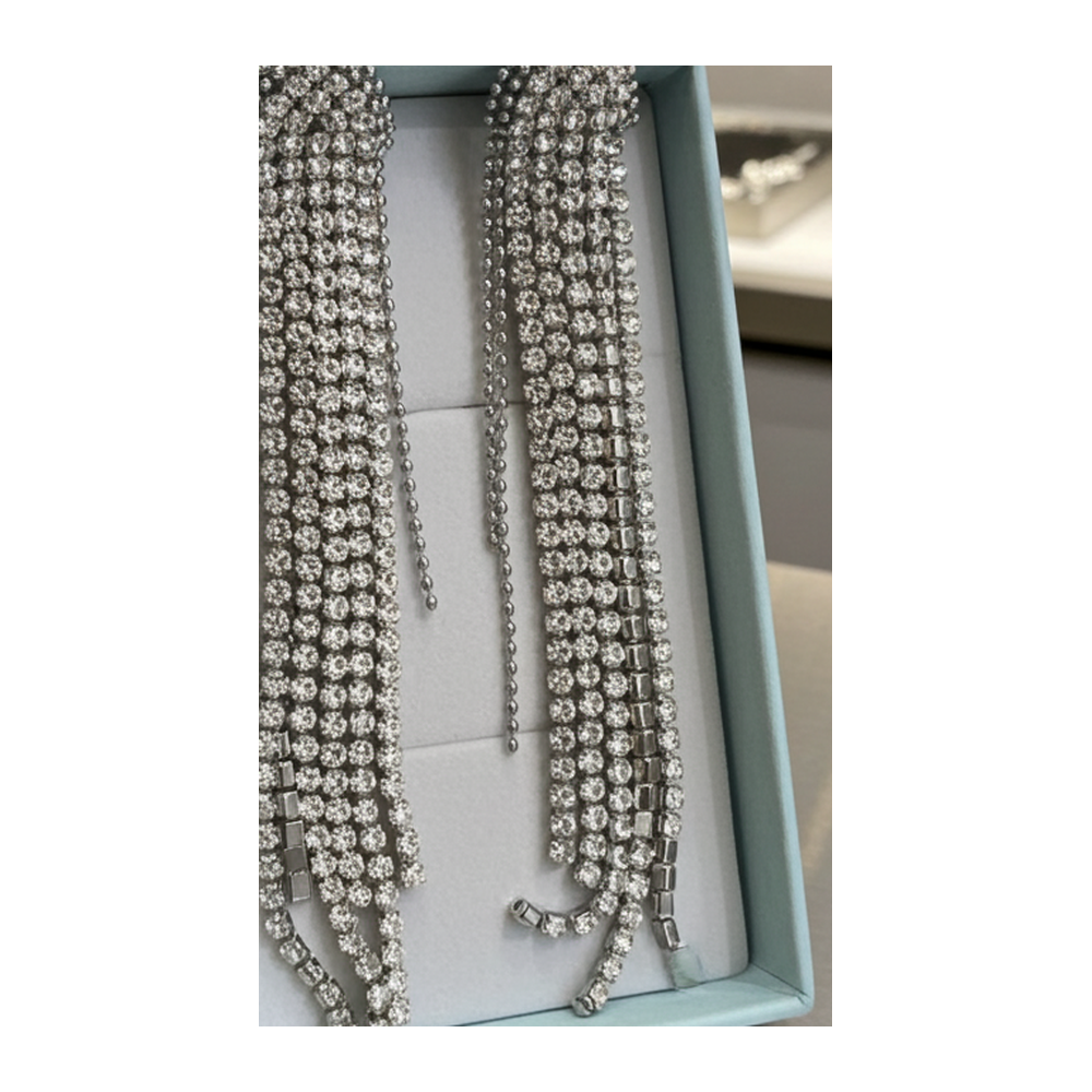 Long multi-strand rhinestone fringe statement earrings, silver-tone, plain background
