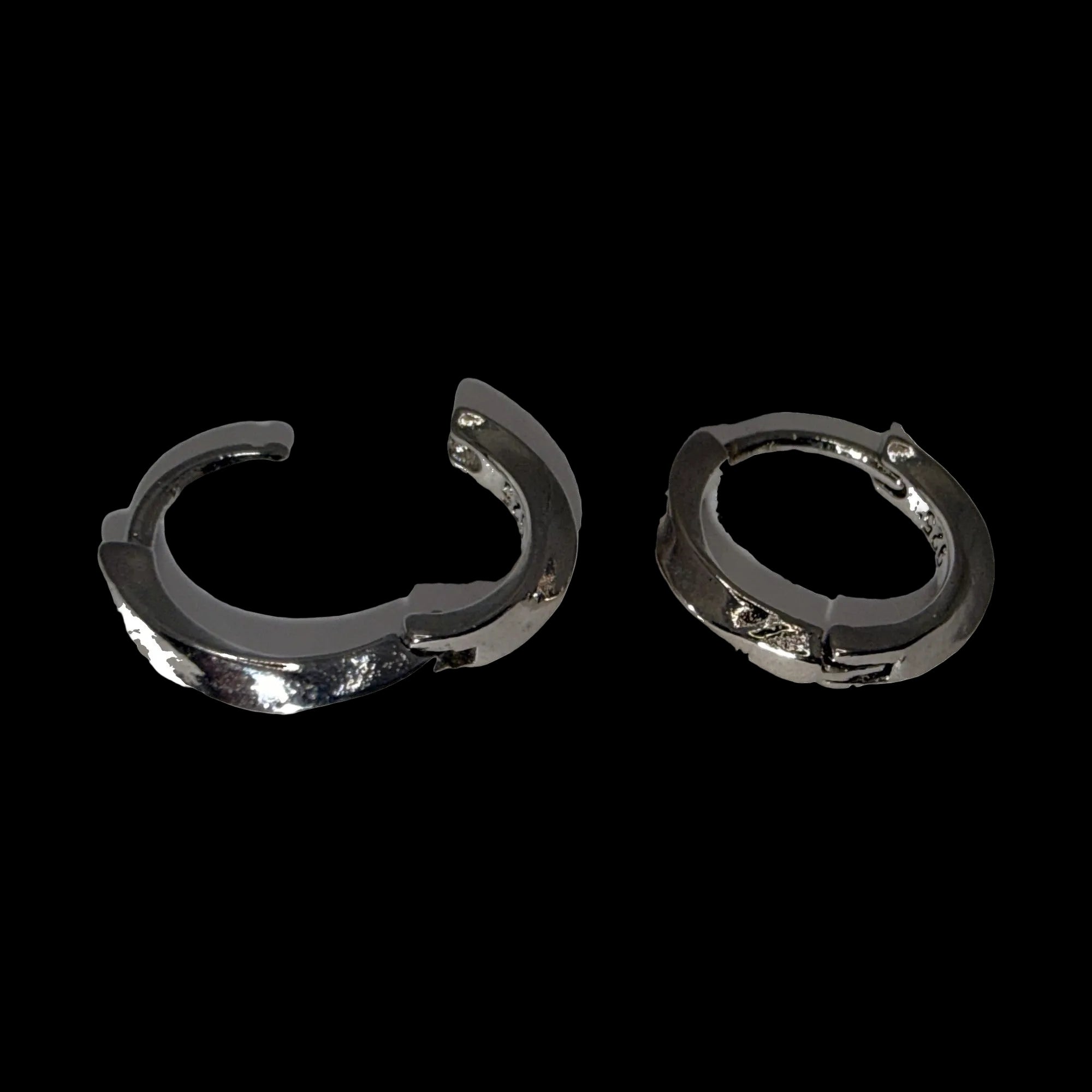 Small polished silver-tone slim huggie hoop earrings, one hoop open showing the hinge