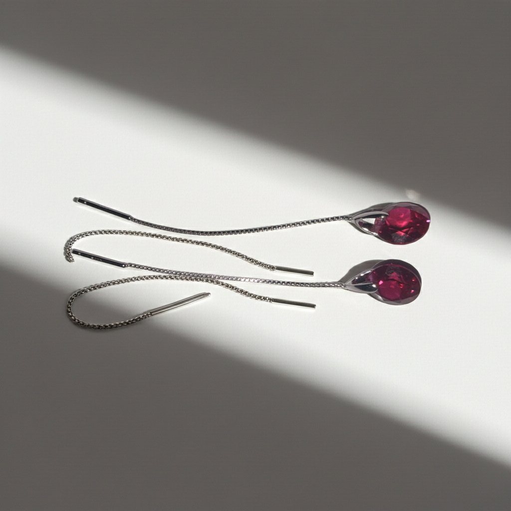 Red teardrop rhinestone chain threader earrings on fine silver-tone chain, detail view