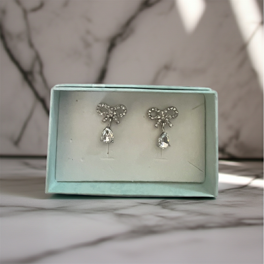 Pave rhinestone bow stud earrings with a faceted clear teardrop drop, silver-tone, alternate view