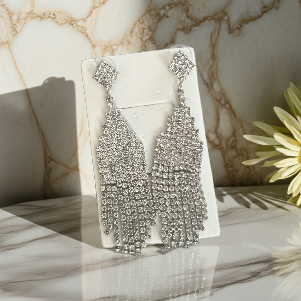 Clear rhinestone chandelier fringe statement earrings in silver-tone with graduated strands, detail view